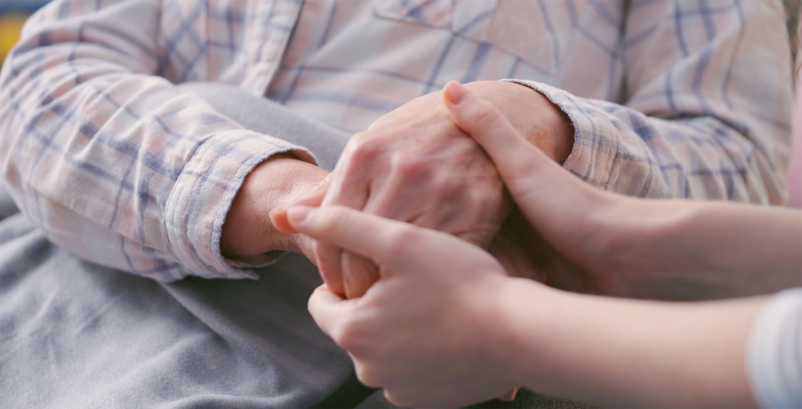 Caring hands supporting a patient in hospice care